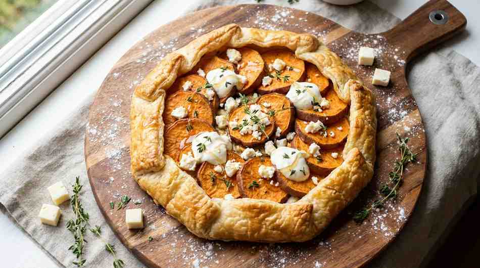 Freshly baked sweet potato galette with crispy puff pastry edges, caramelized sweet potato slices, goat cheese crumbles, and thyme garnish, Sweet Potato Galette Recipe ready to serve.